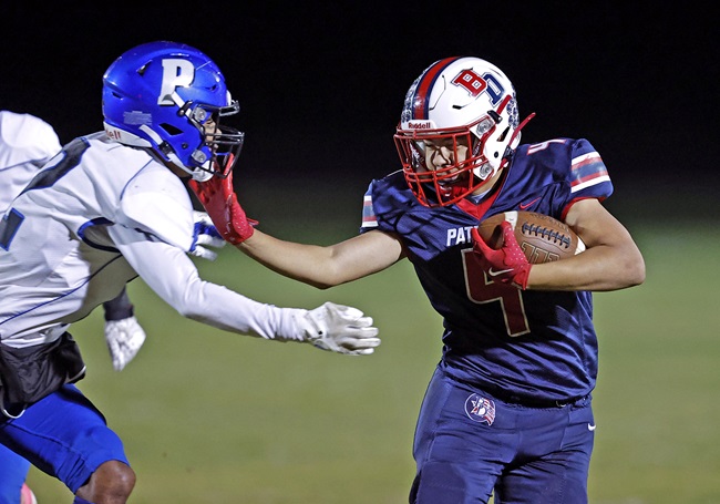 Luke Wiser (4) takes on a Pittsford tackler.