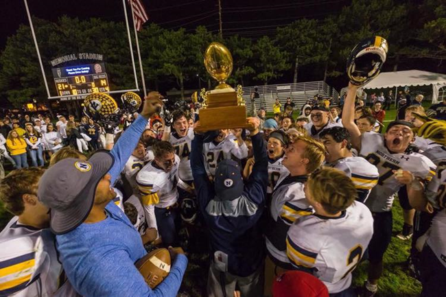 Roelens hoists the Brick Fowler Trophy after a Northern win over rival Port Huron. 