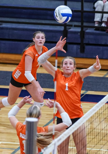 Layla Visser (1) winds up for a kill attempt with Izzie Delacher setting and Liz Hosford (14) also approaching the net.