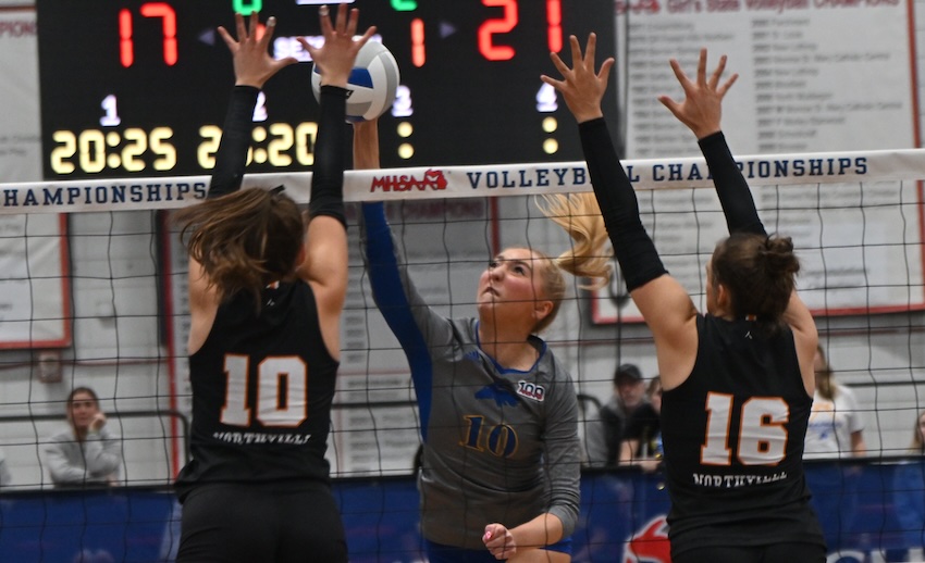 Marian’s Jayla Zayti works to get a ball past Northville’s Mallory Reck (10) and Chenowith (16). Zayti finished with six kills and seven blocks, while Reck had 18 kills and four blocks, and Chenowith had three blocks.