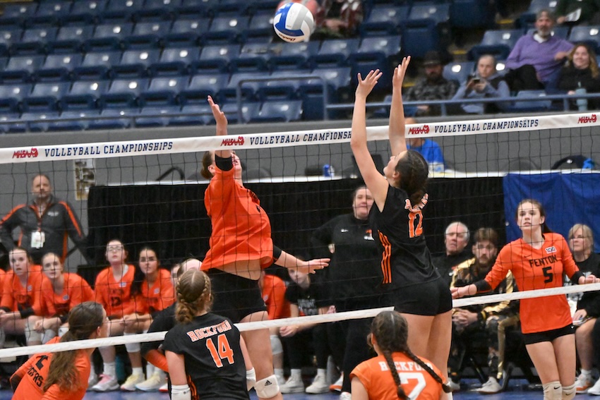 A Fenton player and Rockford's Grace Crelly (12) meet at the net of the second Division 1 Semifinal. Crelly finished with five kills in the Rams’ 25-12, 25-14, 25-8 victory.