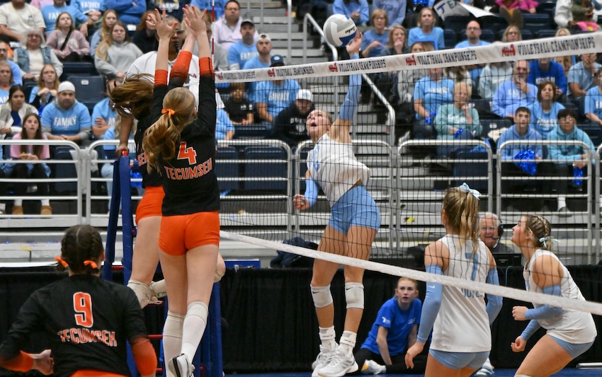 Essexville Garber’s Audrey Ball connects as Tecumseh’s Lauren Kilbarger (4) and a teammate put up a block in Division 2. Tecumseh advanced with an 18-25, 24-26, 25-20, 25-19, 15-13 victory. Ball finished with 27 kills as the Dukes closed the season 43-13-2.