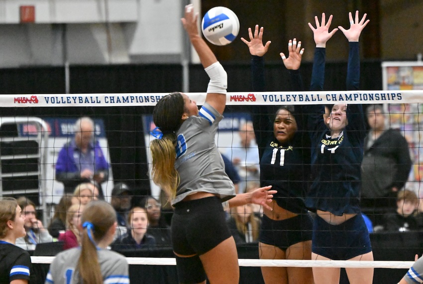 Harper Creek’s Camille Robinson sends a kill attempt toward Green and Country Day teammate Sici Guerrant. Robinson finished with 15 kills as the Beavers ended the season 52-5.