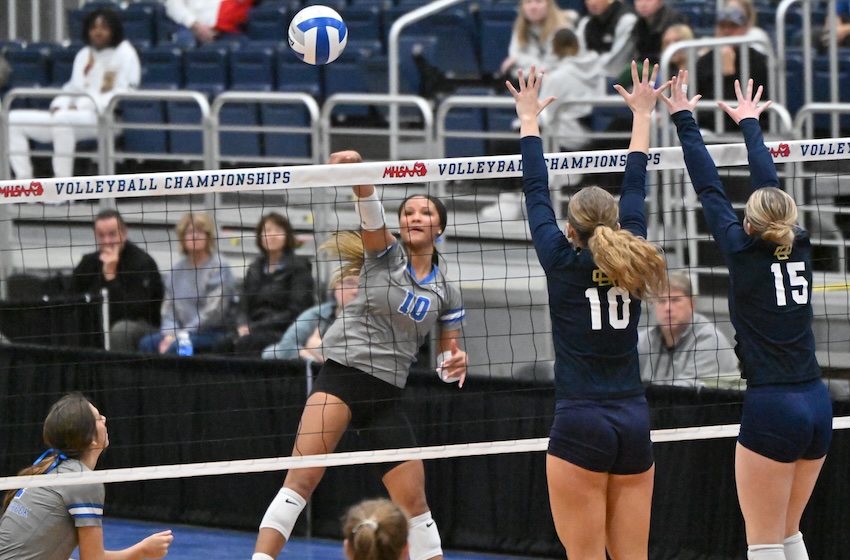 Harper Creek’s Camille Robinson (10) sends a kill attempt toward the Country Day side of the court.