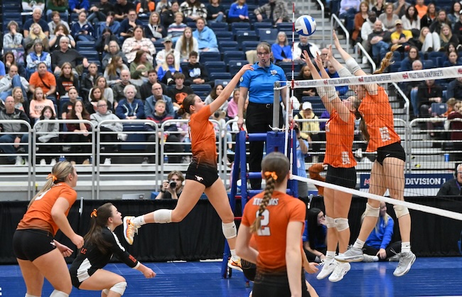 The Mustangs’ Molly Reck (8) sends a spike into an awaiting Rockford block. 