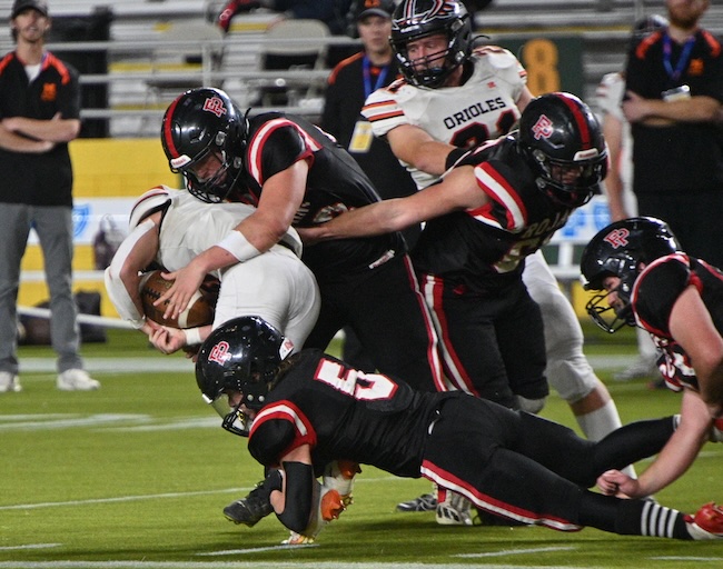 Forest Park’s Kevin Giuliani and Brody Starr (5) bring down an Orioles ball carrier. 