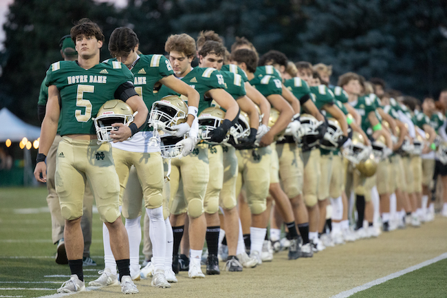 The Fighting Irish, including Drew Heimbuch (5), line up before a game.