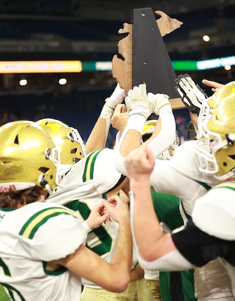 NDP players hold up their championship trophy toward the crowd.