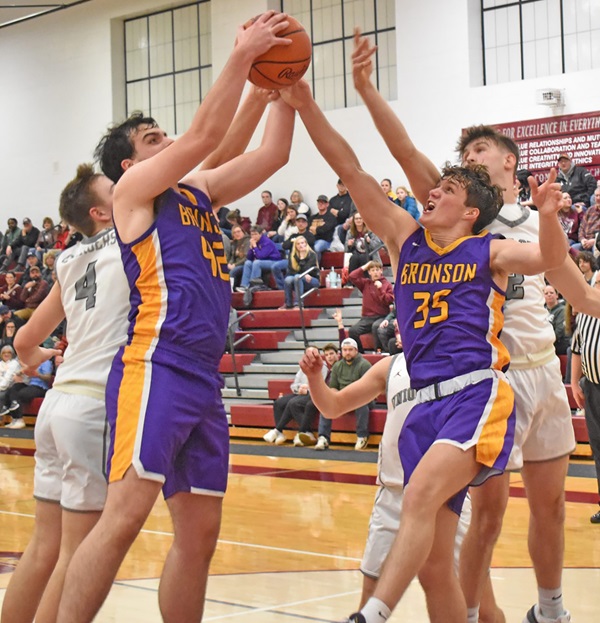 Bronson senior post player Boston Bucklin (35) battles for a rebound in a District game against Union City last winter. 