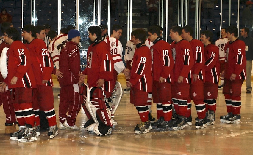 Marquette and Orchard Lake St. Mary's hockey players shake hands after their record-setting championship game.