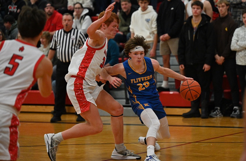 Kingsford's Gavin Grondin (20) makes a move toward the basket while being defended by Marquette's Jacob MacPhee on Friday.