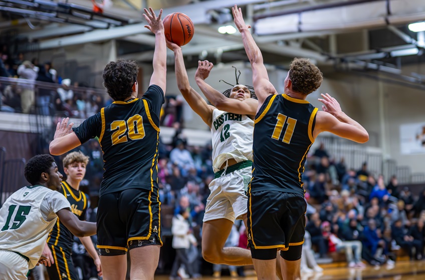 Detroit Cass Tech’s Donavin Eddins (12) gets up a shot in traffic during his team’s 68-57 win over Rochester Adams on Dec. 30. 