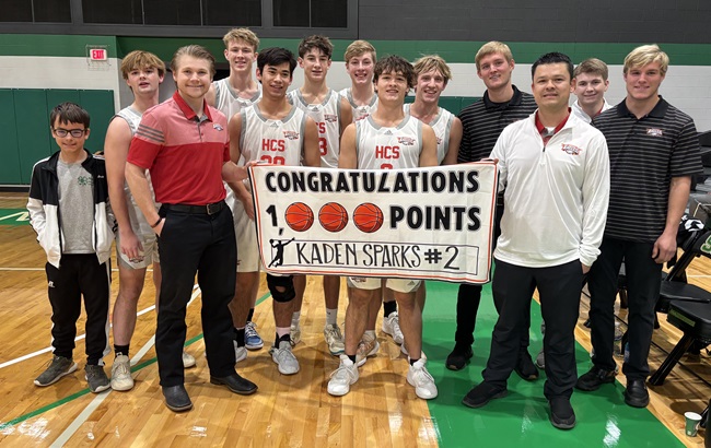 Howardsville Christian teammates and coaches pose for a photo after Sparks surpassed 1,000 points for his career during a loss to Edwardsburg in the Tri-State Holiday Classic at Southwestern Michigan College. 