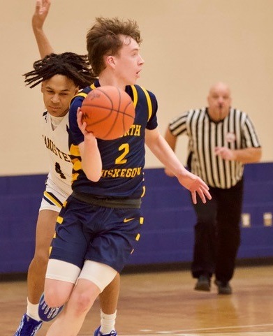 Dugener (2) considers his options as he reaches midcourt. 