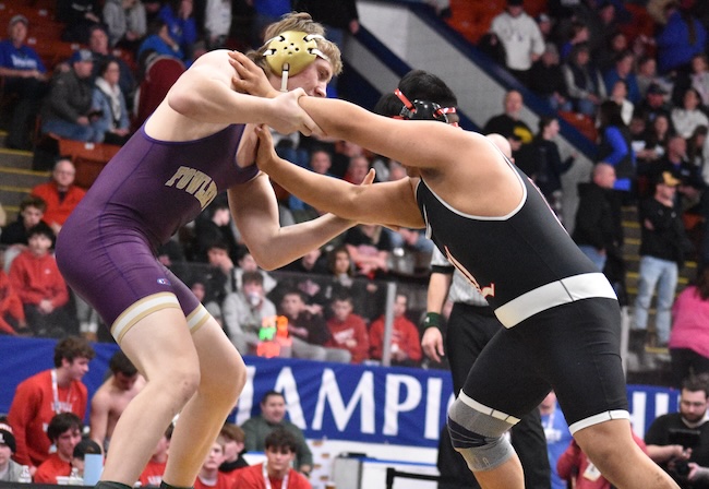 Layne O'Neil de Fowlerville, on the left, works towards a victory at 215 pounds. 