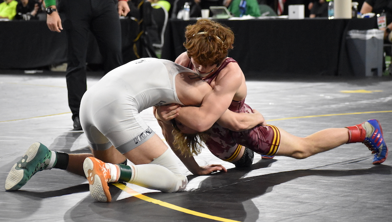 Manchester’s Blake Sloan, right, gets leverage during his match with New Lothrop’s Dalton Birchmeier.