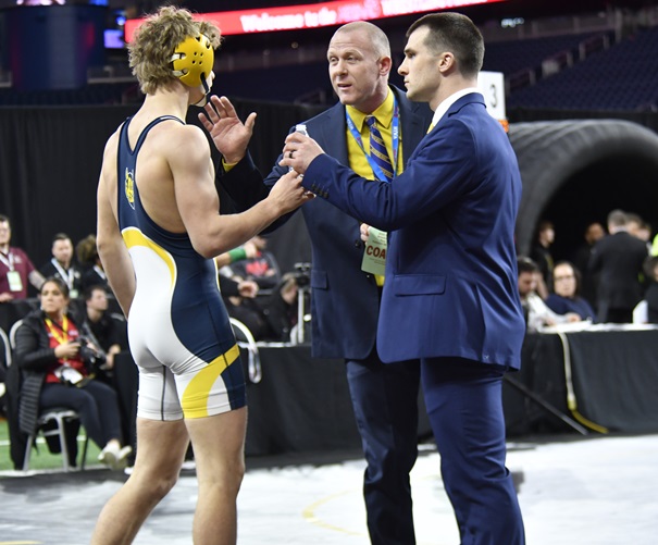 Bensinger listens in to Blue Devils head coach Casey Stradling, center, and assistant Dan Cornish during a break in his championship match.