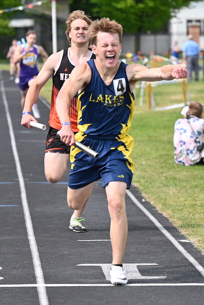 Lake Linden-Hubbell's Lukas Axford celebrates his team's win in that race.