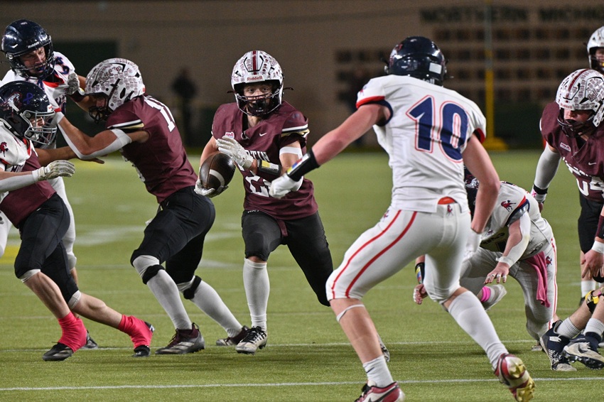 Martin’s Seth Toris (24) charges through a hole with Montabella’s Noah Carlson lining up to attempt a tackle in 8-player Division 1.