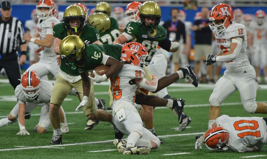 Kingsley’s Nolan Hodges (28) wraps up Lumen Christi’s Ayden Gatewood in Division 6.