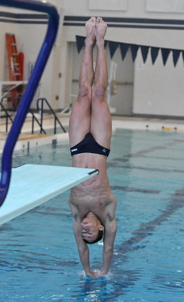 Dawson descends into the water during a dive.